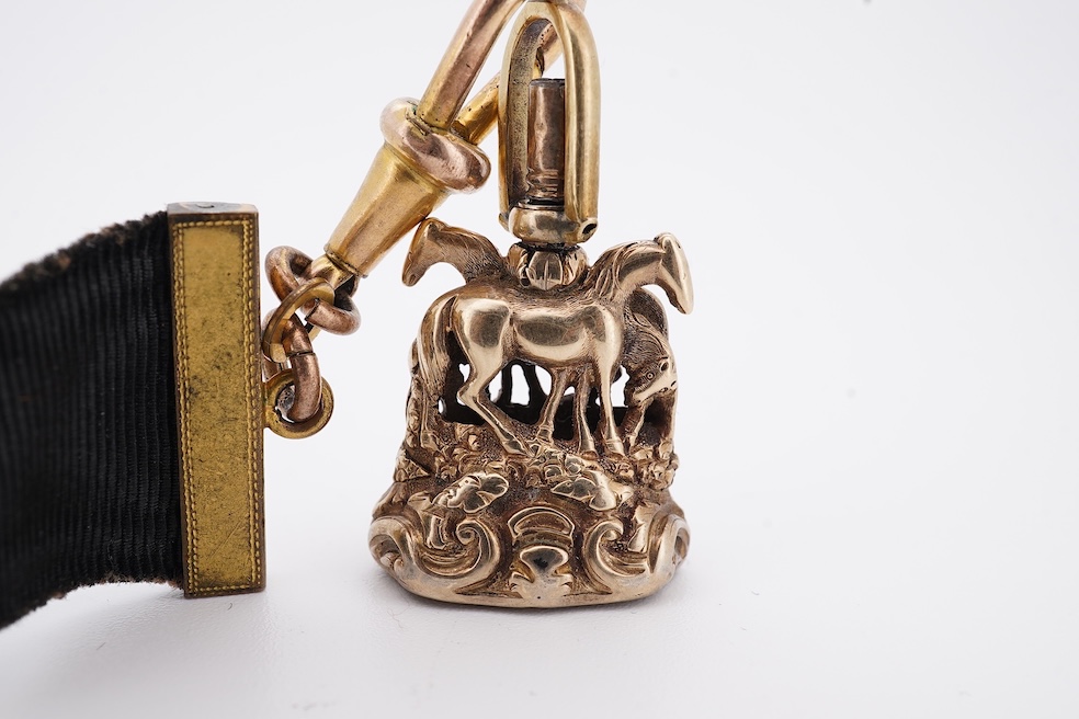 A late Victorian yellow metal overlaid and citrine set watch key fob, depicting two horses and two rams?, 30mm on a black sash suspension, together with a modern pair of 9ct gold and cultured pearl set leaf ear studs. Co